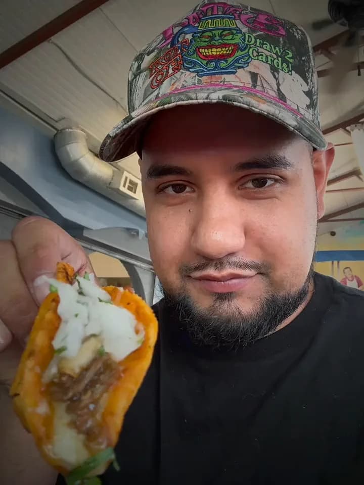Brandon holding a taco up to the camera
