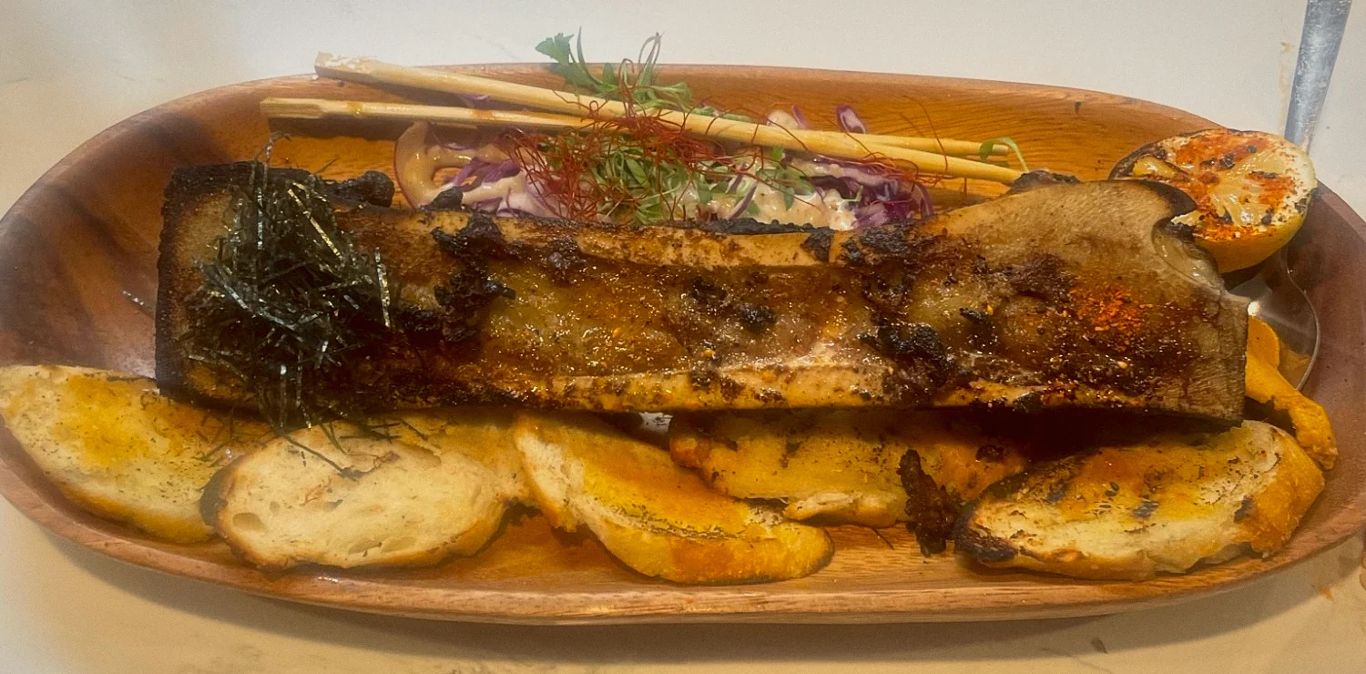 Roasted bone marrow with shredded nori, grilled bread and a charred lemon